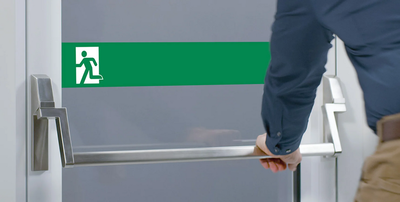 Das Bild zeigt einen Mann beim Verwenden einer Panikstange.